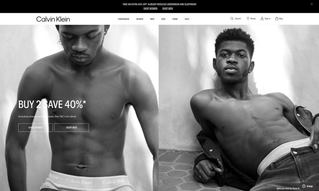 Two black-and-white photos of a shirtless man in Calvin Klein underwear appear on the homepage, showcasing an Integrated Marketing Communication approach and promoting a "Buy 2 Save 40%" offer.