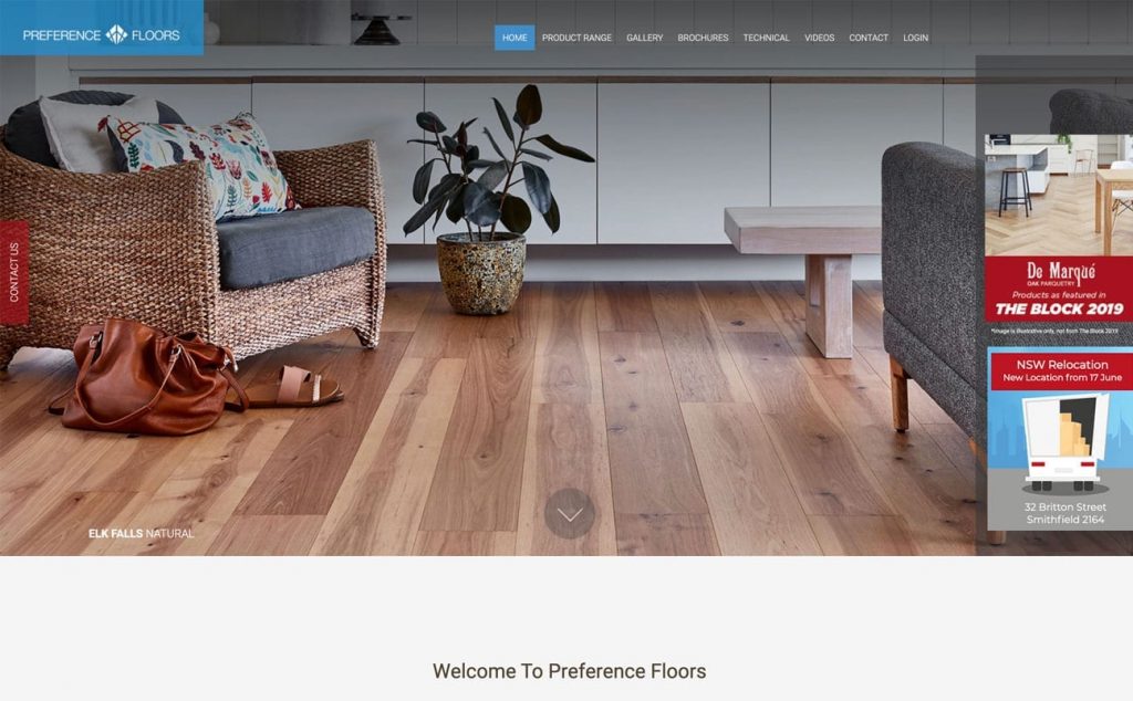 Flooring showroom featuring diverse wood floors, a chair with a cushion, a potted plant, and a wooden table with a red handbag on the floor. Tabs for different page sections are intuitively designed at the top, showcasing excellent user interface principles in website development.