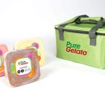 Three containers of Pure Gelato in assorted flavors are displayed next to a green insulated bag branded with the Pure Gelato logo.