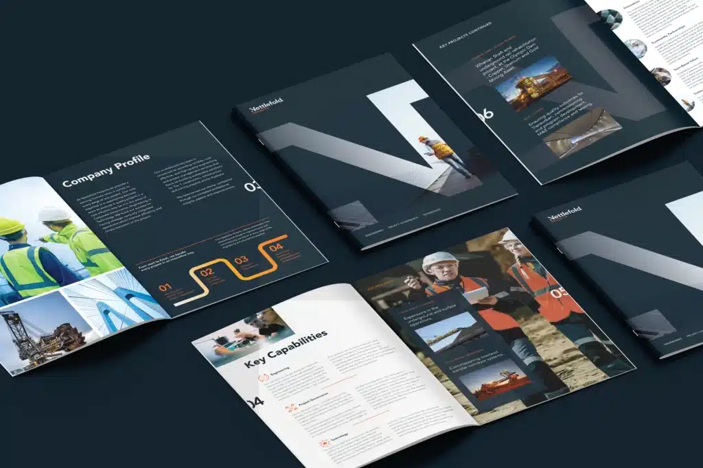 Assorted corporate brochure layouts spread out, showcasing different design and content sections focusing on company information and staff profiles.