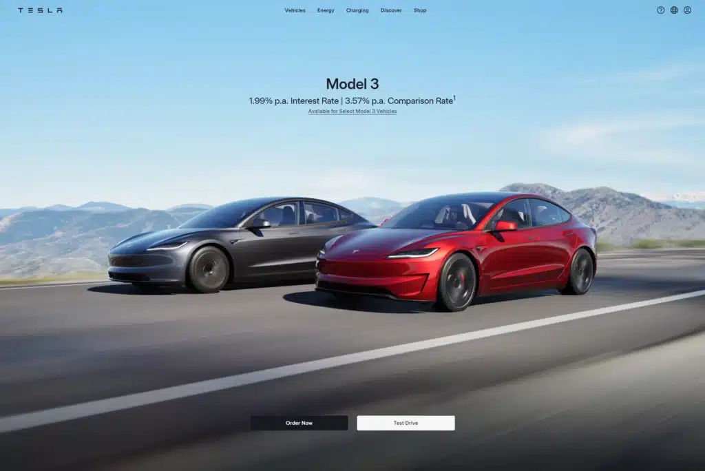 Two Tesla Model 3 cars, one black and one red, driving on a road with mountains in the background. Text above them specifies financing rates and availability for Tesla Model 3 vehicles. Ideal for those looking to merge cutting-edge technology with nature's beauty, all guided by intuitive AI prompts.
