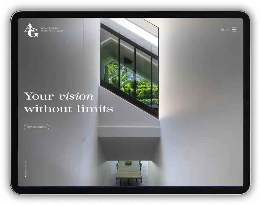 Interior view of a modern building showcasing a large window with lush greenery outside and a table below. Text on the image reads "Your vision without limits" and "Get in touch." The A&G Architectural Glass logo is displayed prominently.