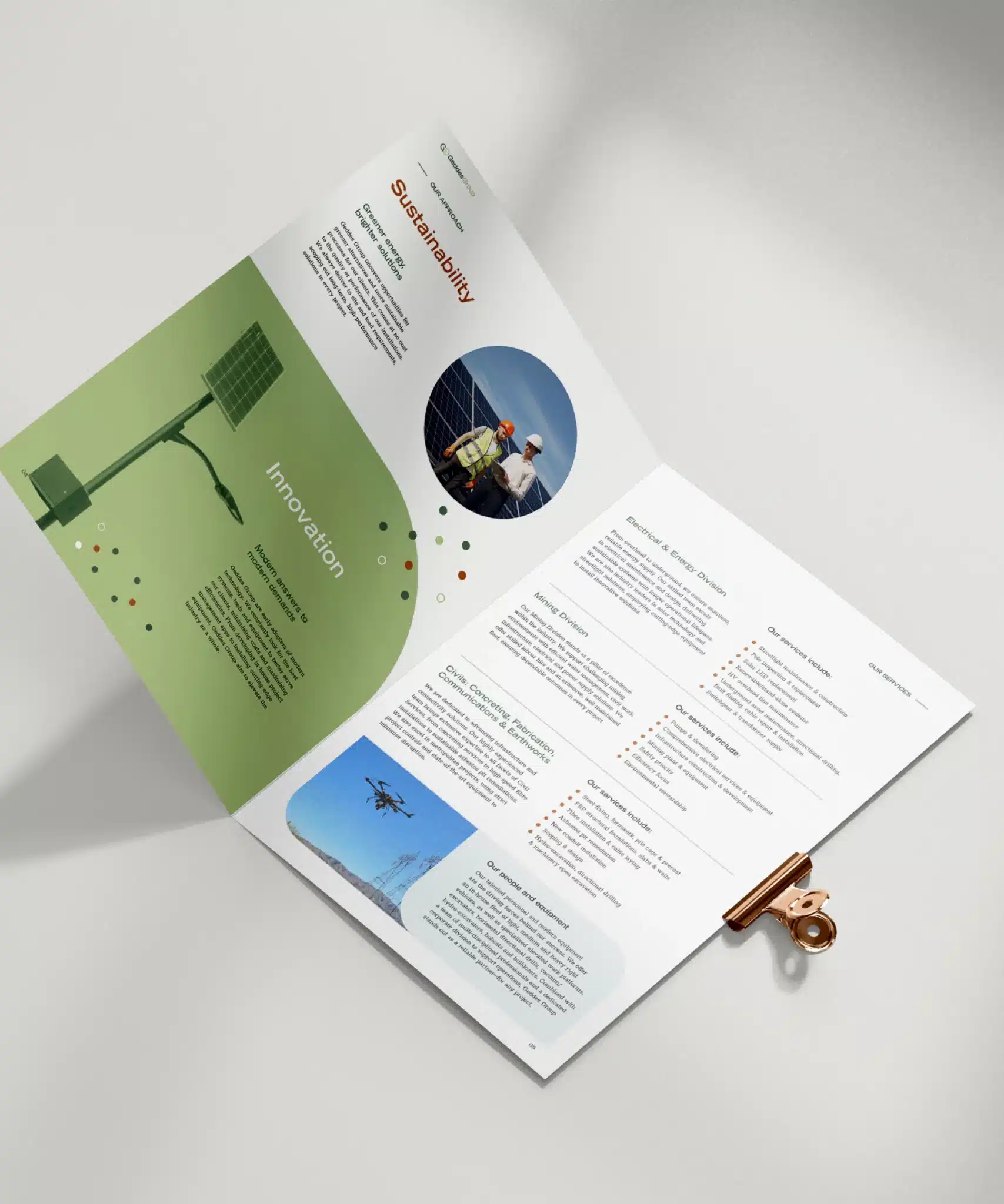 Open brochure on a table, featuring sections on sustainability and innovation. Contains photos, text, and green design elements, with a copper clip holding the pages.