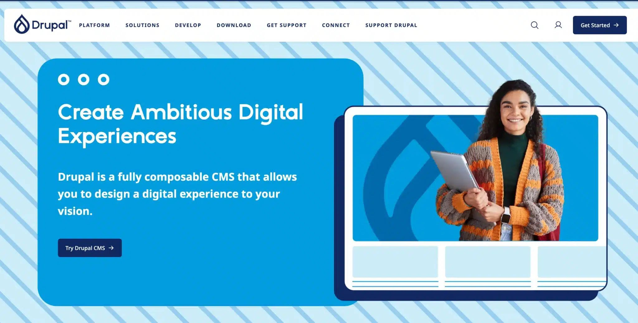 An individual with a laptop stands beside a screen showcasing "Create Ambitious Digital Experiences" with Drupal branding, a perfect pick for eCommerce CMS needs, especially tailored for Australian businesses.