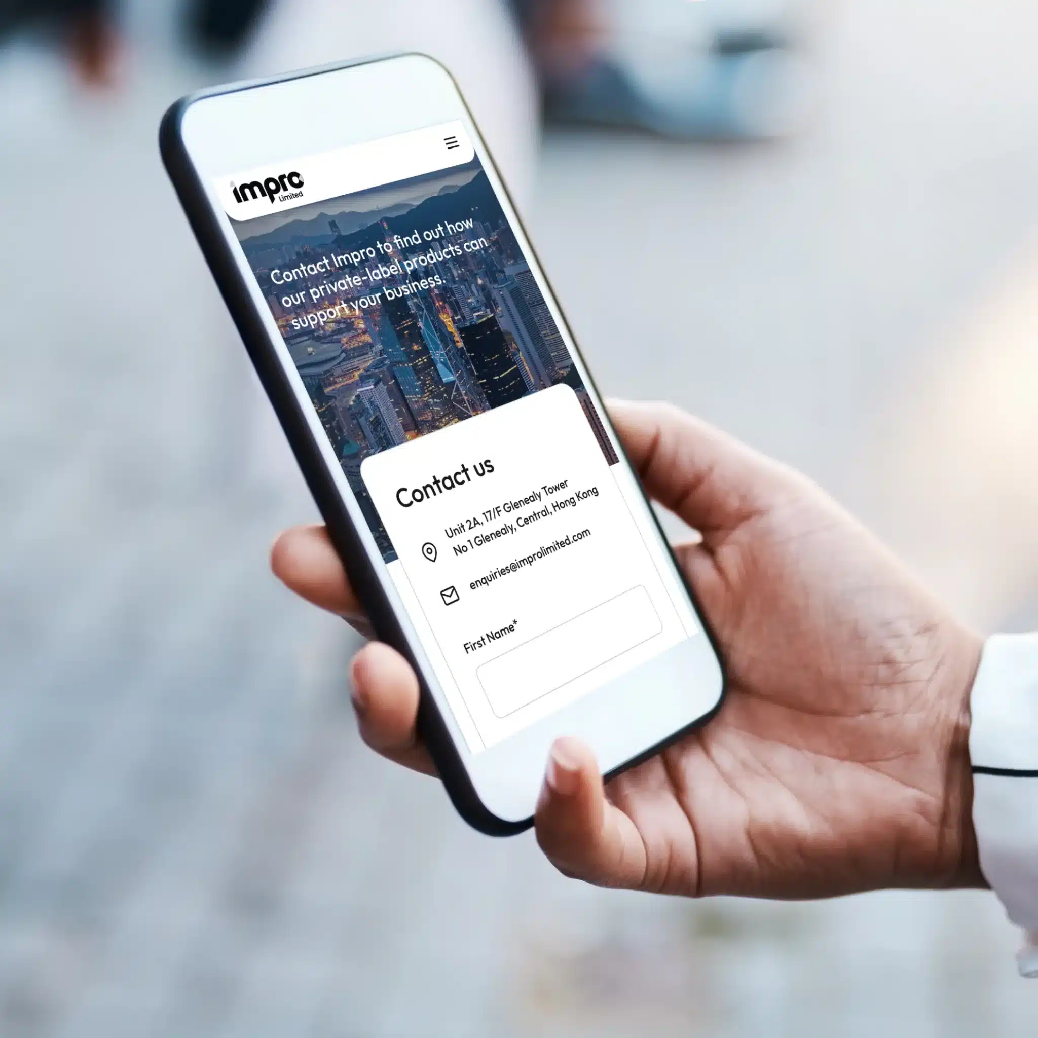 A person holds a smartphone displaying a contact form on the Imprc Consulting website, showcasing fields for name and email—reflecting Impro Limited's commitment to a premium experience.