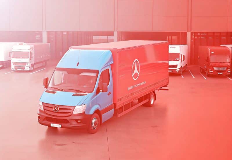 A blue and red Mercedes-Benz delivery truck is parked in a lot with other trucks and a warehouse in the background—perfect for high-converting Ecommerce product pages in Australia.