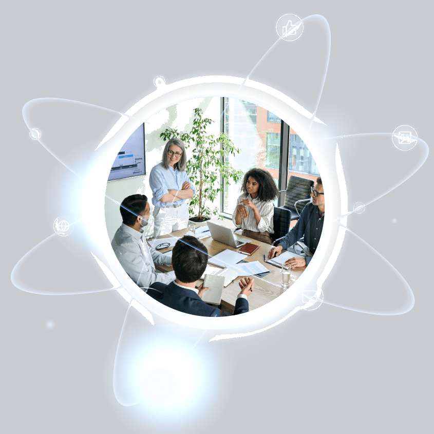 Five professionals having a business meeting around a table, with digital icons and glowing lines circling them—highlighting the power of a Capability Marketing system in today's connected world.