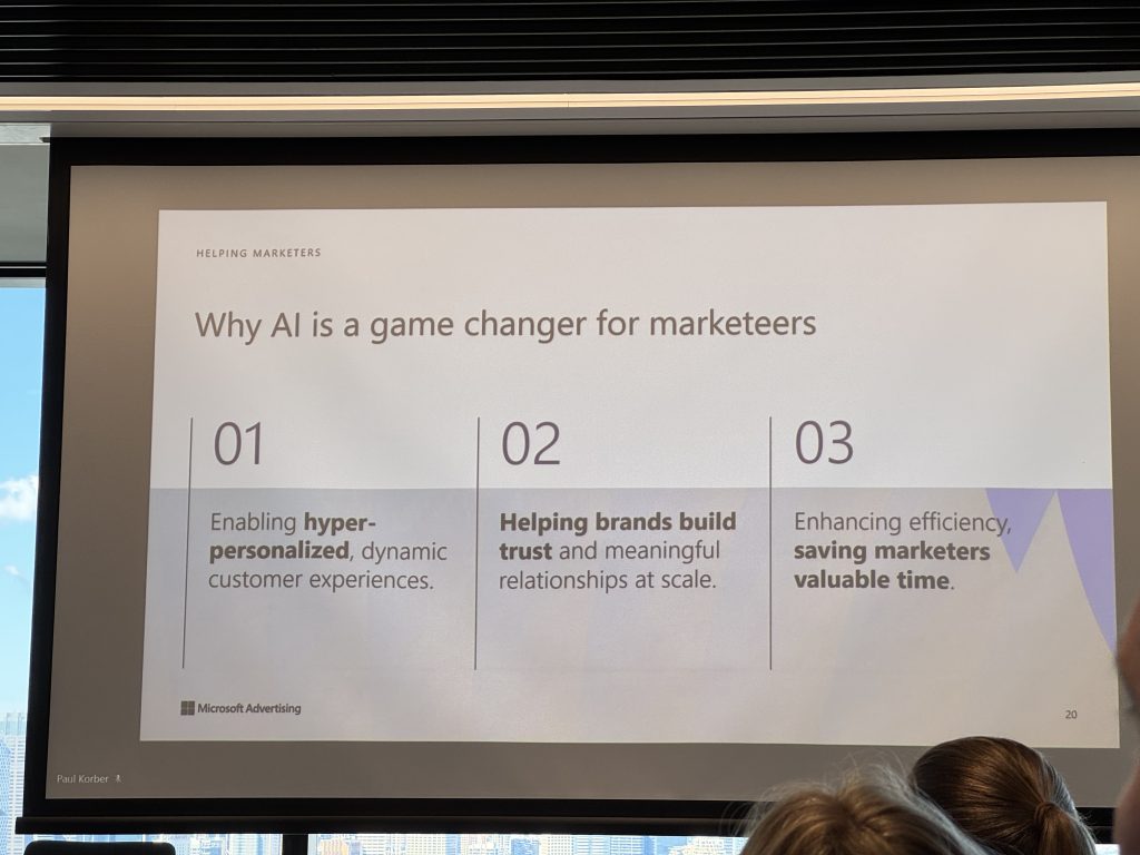 A presentation slide titled "Why AI is a game changer for marketeers" at the Microsoft Marketing Event lists AI benefits: personalization, building trust, and boosting ROI, with bullet points and bolded keywords.